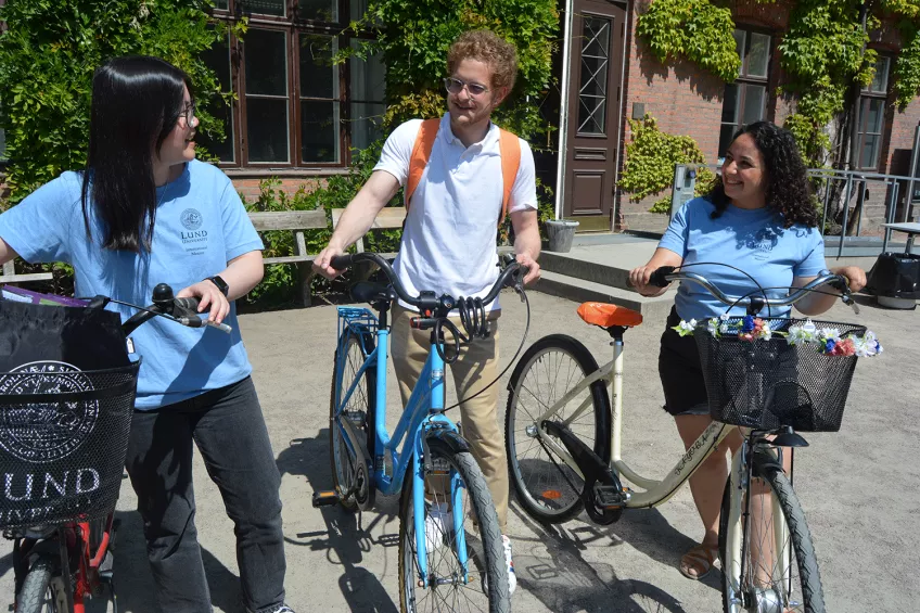 Three mentors on a bike at Lund campus. Photos.